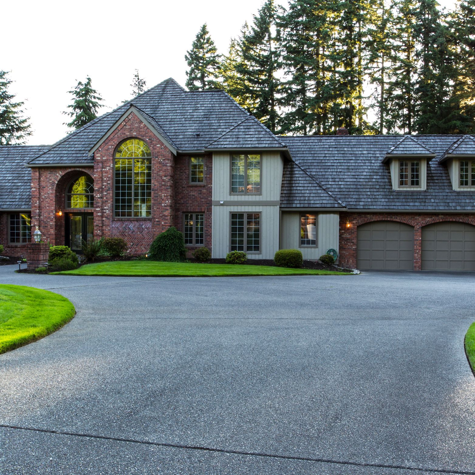 Sealcoated driveway in front of a brick home
